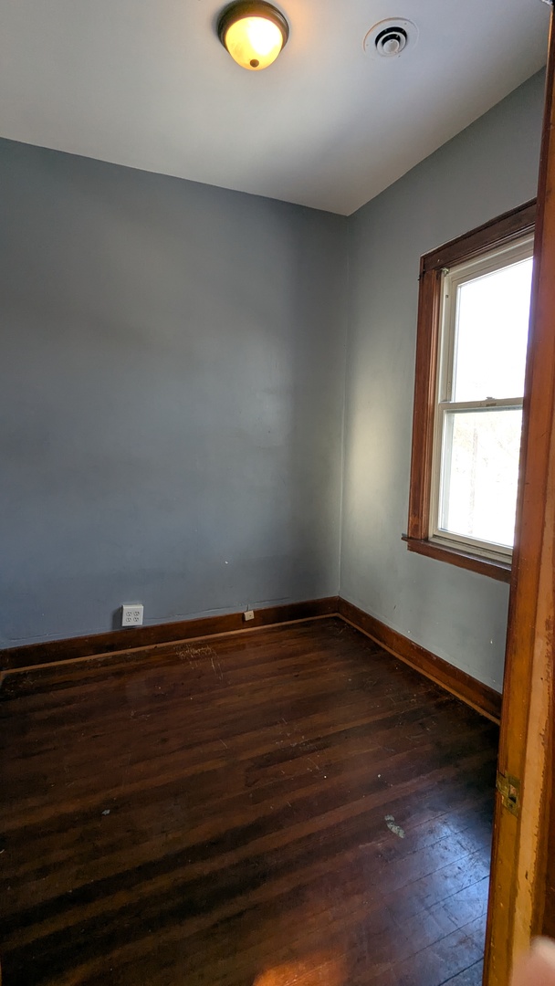8112 South Exchange Avenue Chicago, IL 60617 - Photo 14 of 35 a view of a room with wooden floor and window