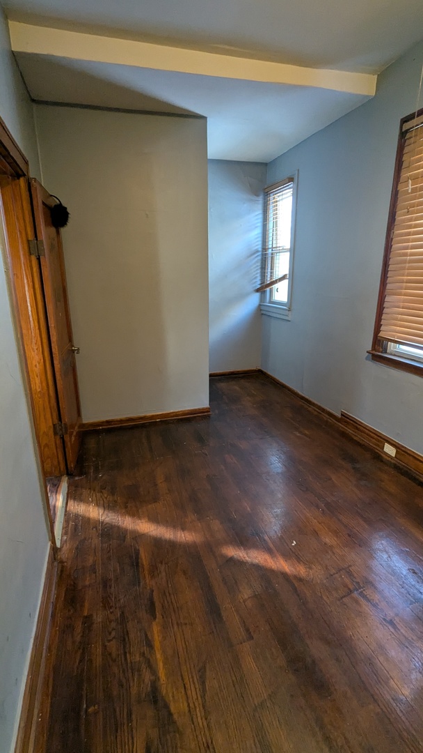 8112 South Exchange Avenue Chicago, IL 60617 - Photo 20 of 35 an empty room with wooden floor and windows