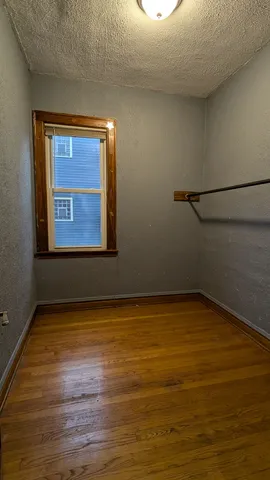 a view of a room with wooden floor and window