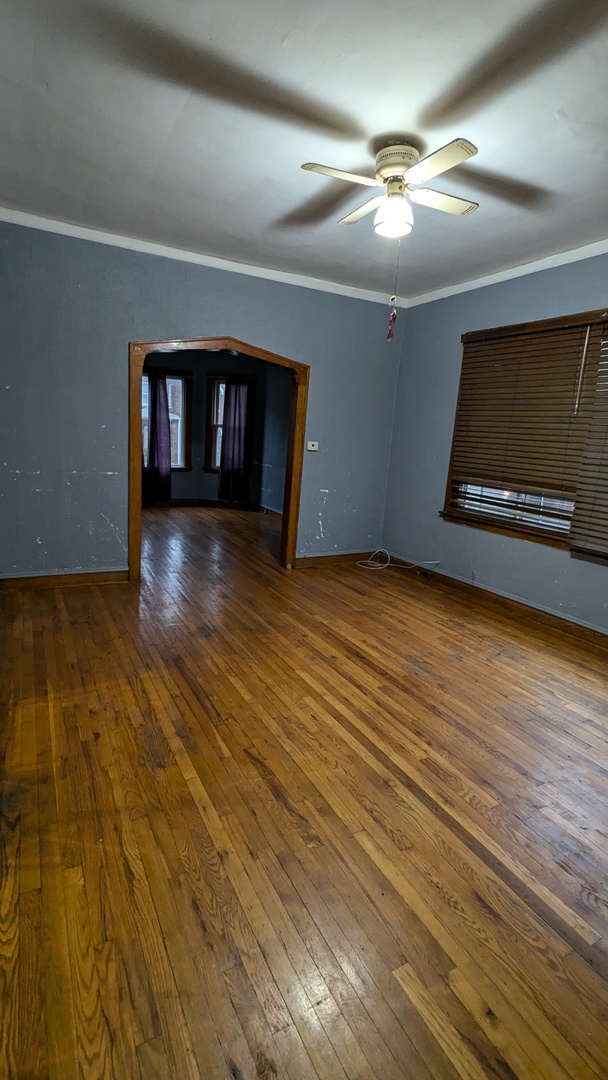 8112 South Exchange Avenue Chicago, IL 60617 - Photo 22 of 35 a view of an empty room with wooden floor and a fireplace