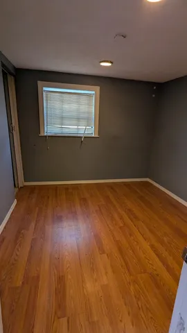 a view of a room with wooden floor and white walls