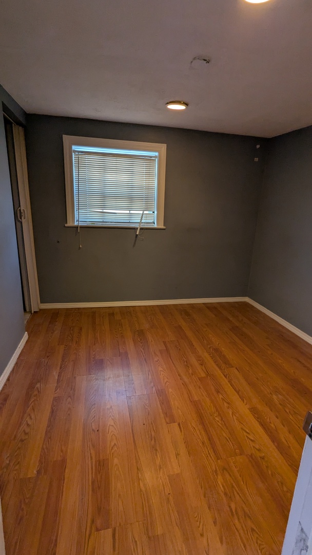 8112 South Exchange Avenue Chicago, IL 60617 - Photo 24 of 35 a view of a room with wooden floor and white walls