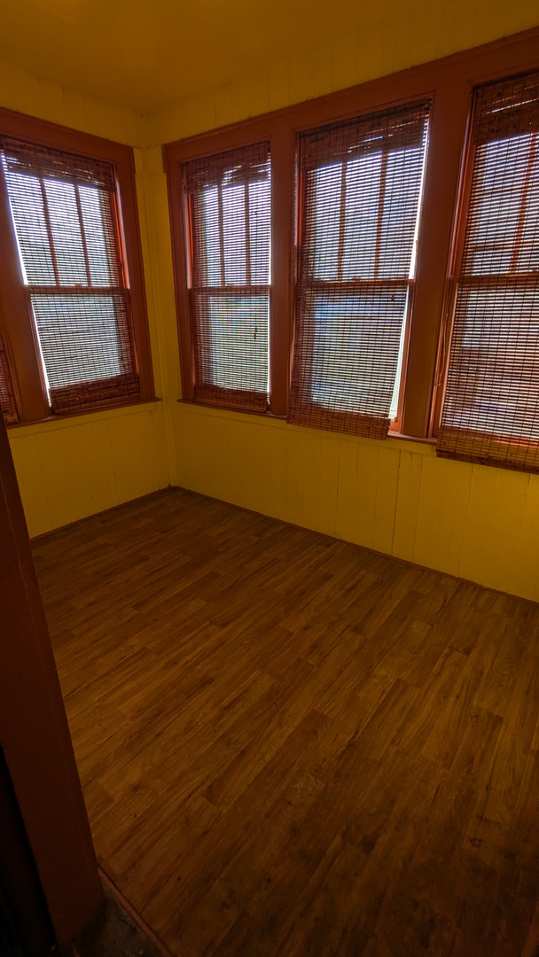 8112 South Exchange Avenue Chicago, IL 60617 - Photo 25 of 35 an empty room with wooden floor and windows