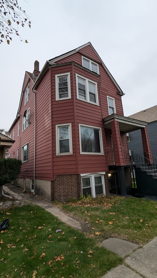 8112 South Exchange Avenue Chicago, IL 60617 - Photo 28 of 35 a front view of a house with a yard