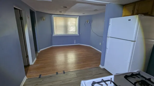 a view of kitchen with refrigerator and window