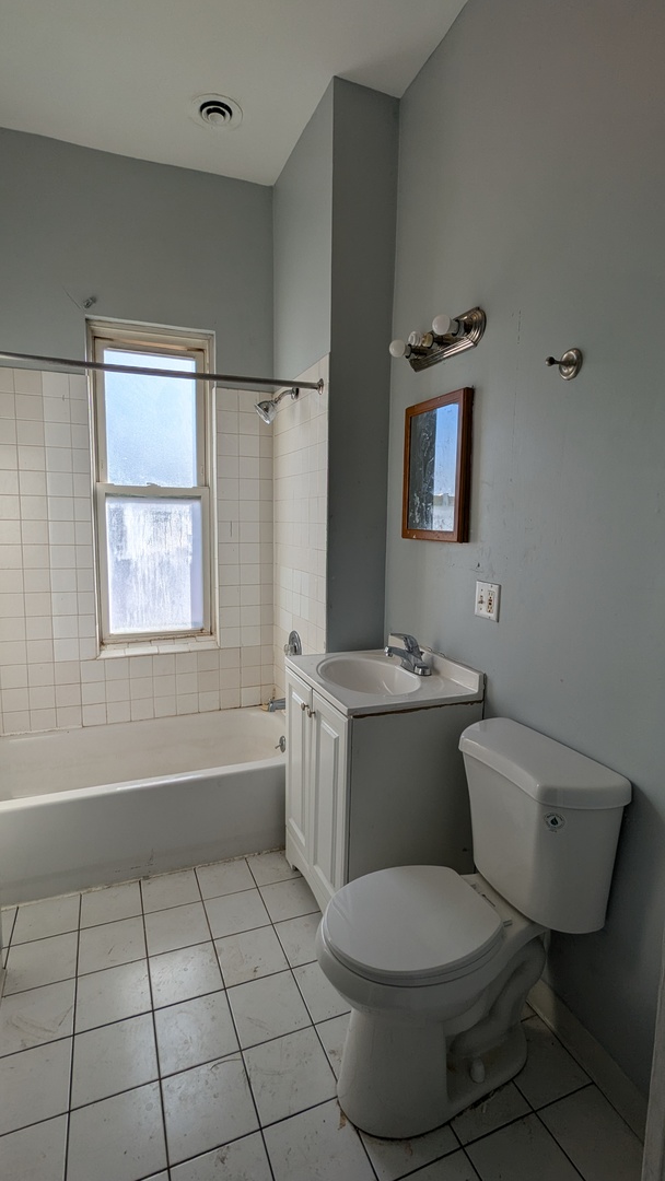 8112 South Exchange Avenue Chicago, IL 60617 - Photo 6 of 35 a bathroom with a toilet sink and mirror
