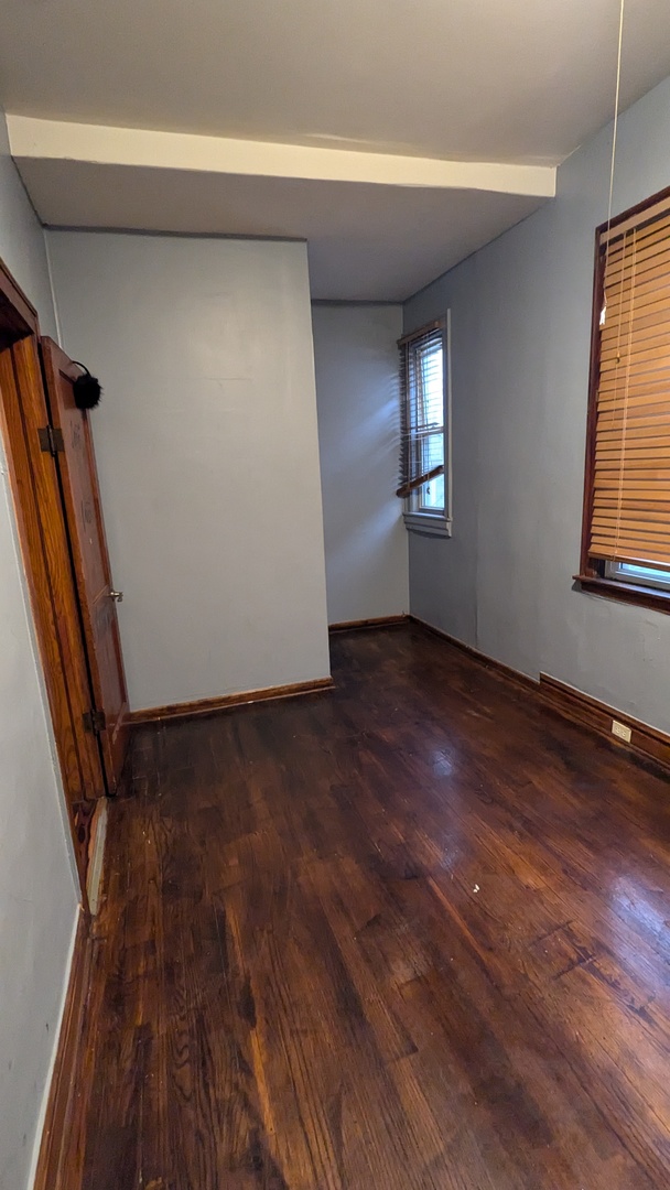 8112 South Exchange Avenue Chicago, IL 60617 - Photo 10 of 35 an empty room with wooden floor and windows