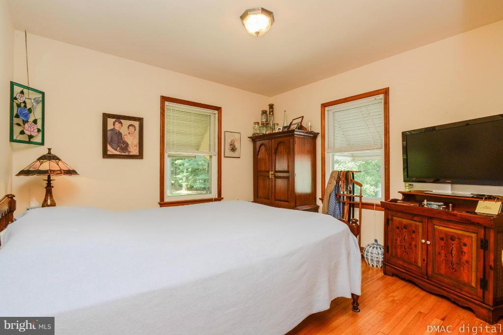 9030 Bethel Road Frederick, MD 21702 - Photo 11 of 28 a bedroom with a bed and a flat screen tv