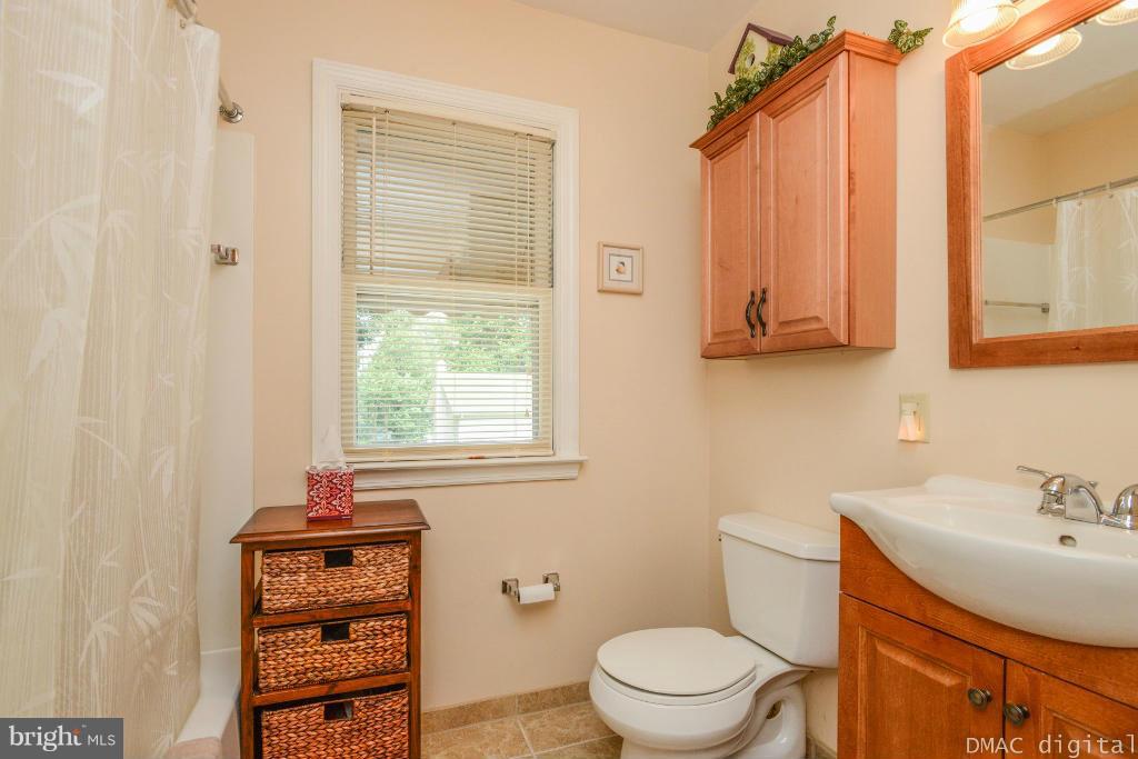 9030 Bethel Road Frederick, MD 21702 - Photo 14 of 28 a bathroom with a sink a toilet and shower curtain