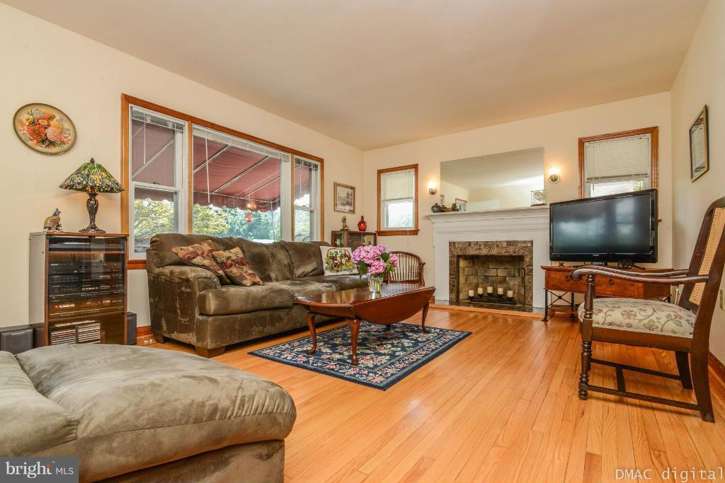 9030 Bethel Road Frederick, MD 21702 - Photo 3 of 28 a living room with furniture a flat screen tv and a fireplace