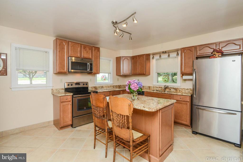 9030 Bethel Road Frederick, MD 21702 - Photo 6 of 28 a kitchen with granite countertop a refrigerator stove top oven a sink and dishwasher