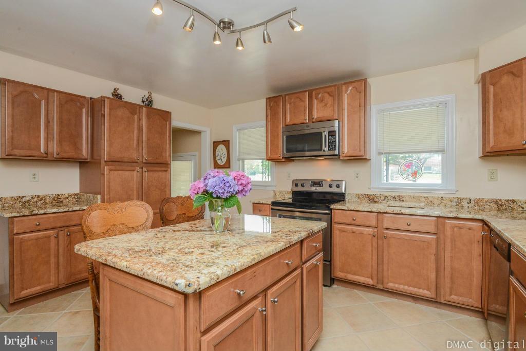 9030 Bethel Road Frederick, MD 21702 - Photo 8 of 28 a kitchen with granite countertop kitchen island stainless steel appliances a sink stove top oven and granite counter top