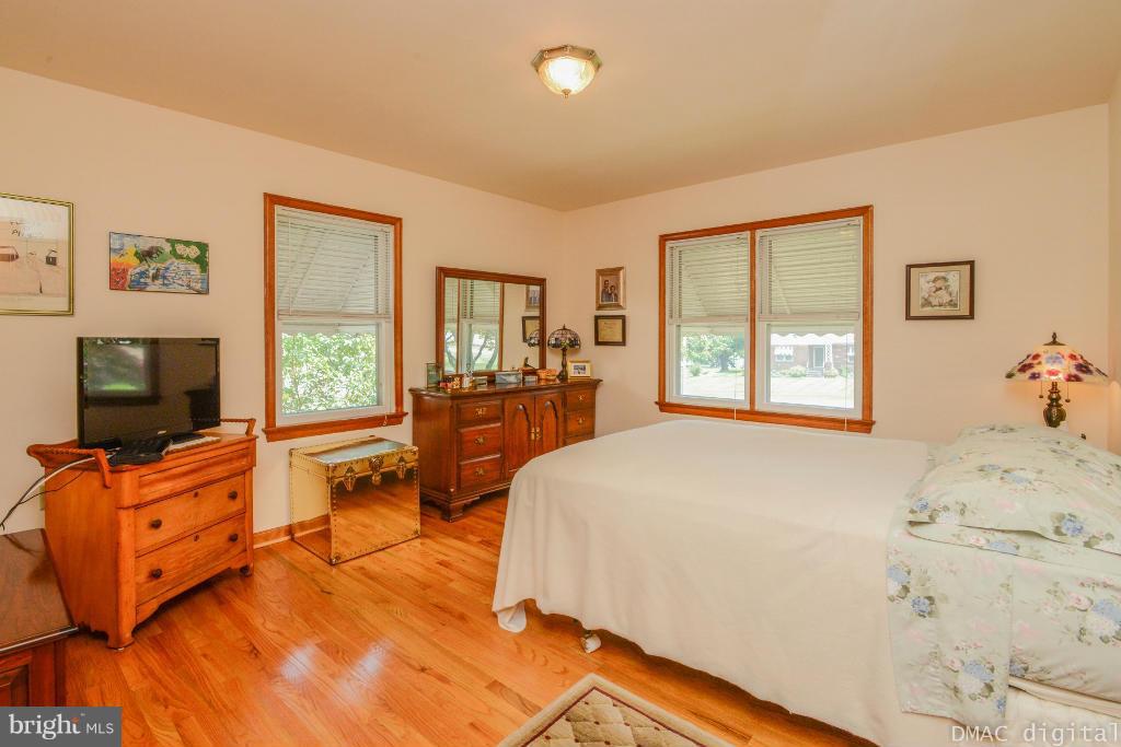 9030 Bethel Road Frederick, MD 21702 - Photo 9 of 28 a bedroom with a bed and wooden floor