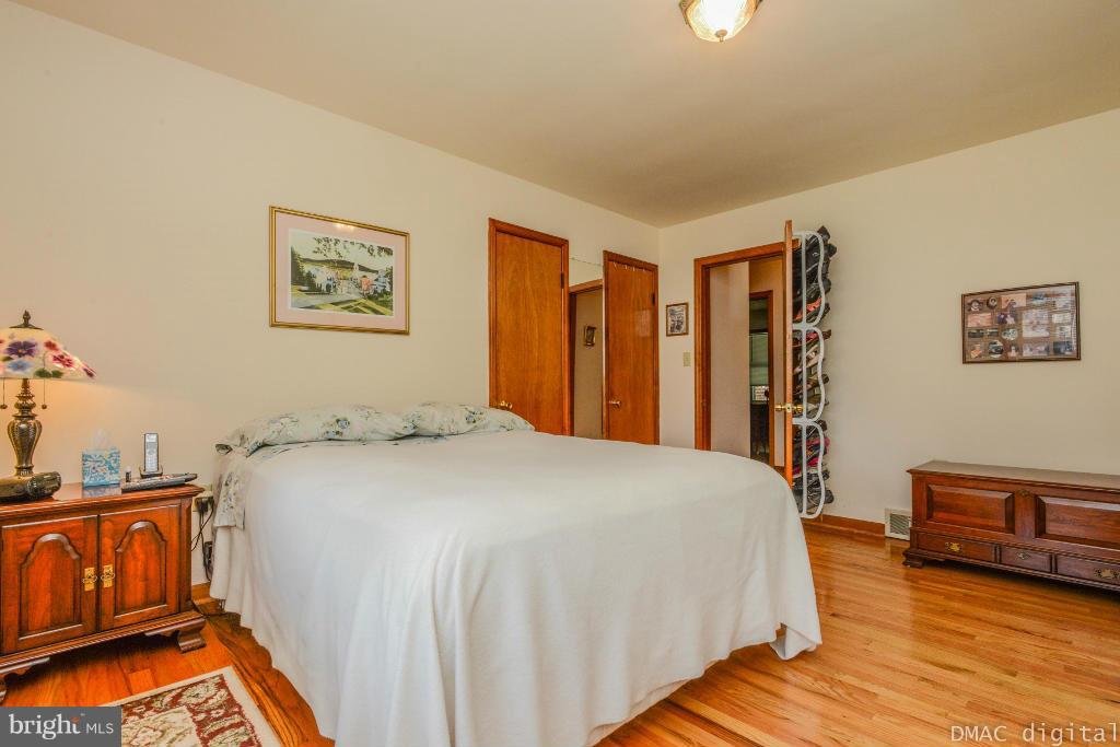 9030 Bethel Road Frederick, MD 21702 - Photo 10 of 28 a bedroom with a bed and wooden floor