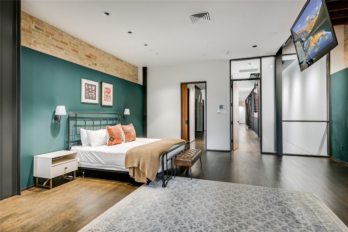 811 Congress Avenue Austin, TX 78701 - Photo 12 of 39 a bedroom with a bed and a refrigerator