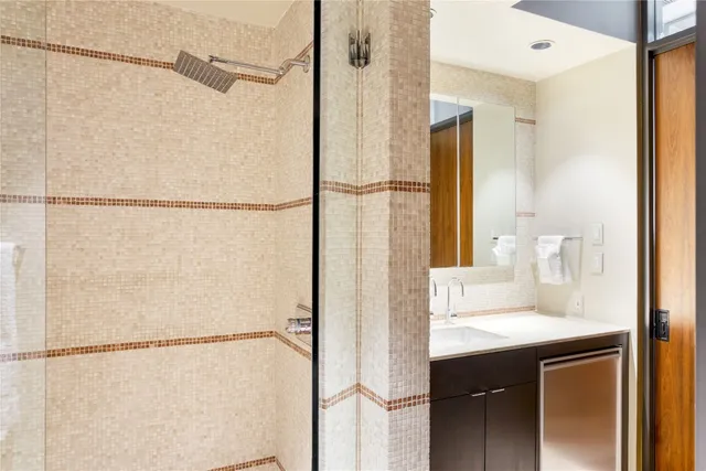 a bathroom with a shower sink and mirror