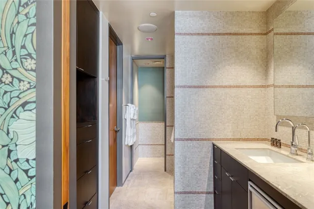 a bathroom with a granite countertop sink and a mirror