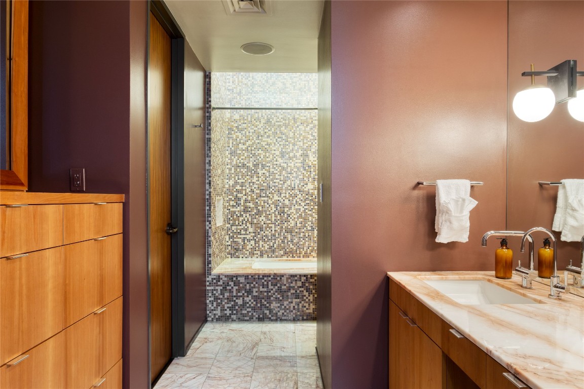 811 Congress Avenue Austin, TX 78701 - Photo 23 of 39 a bathroom with a sink and a mirror