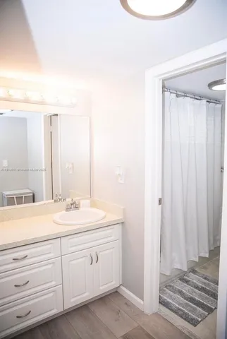 a spacious bathroom with a double vanity sink and a mirror