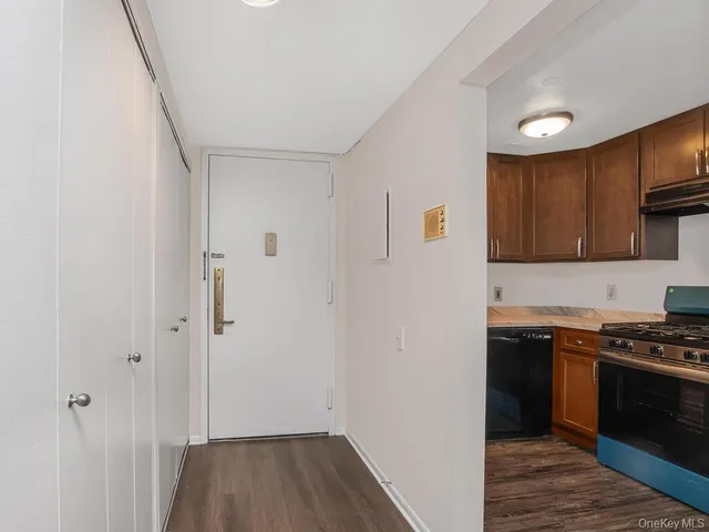 a kitchen with wooden floor and a stove top oven