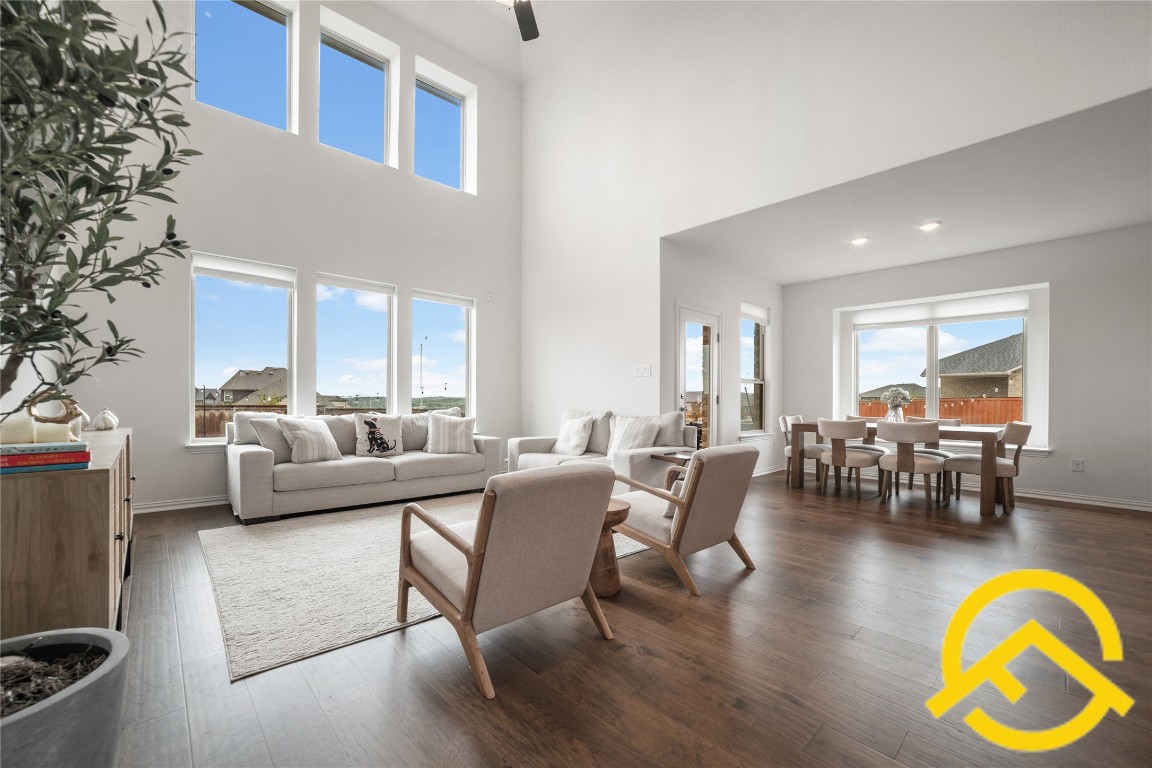 671 Durian Loop Buda, TX 78610 - Photo 9 of 29 a living room with furniture a dining table and a chandelier