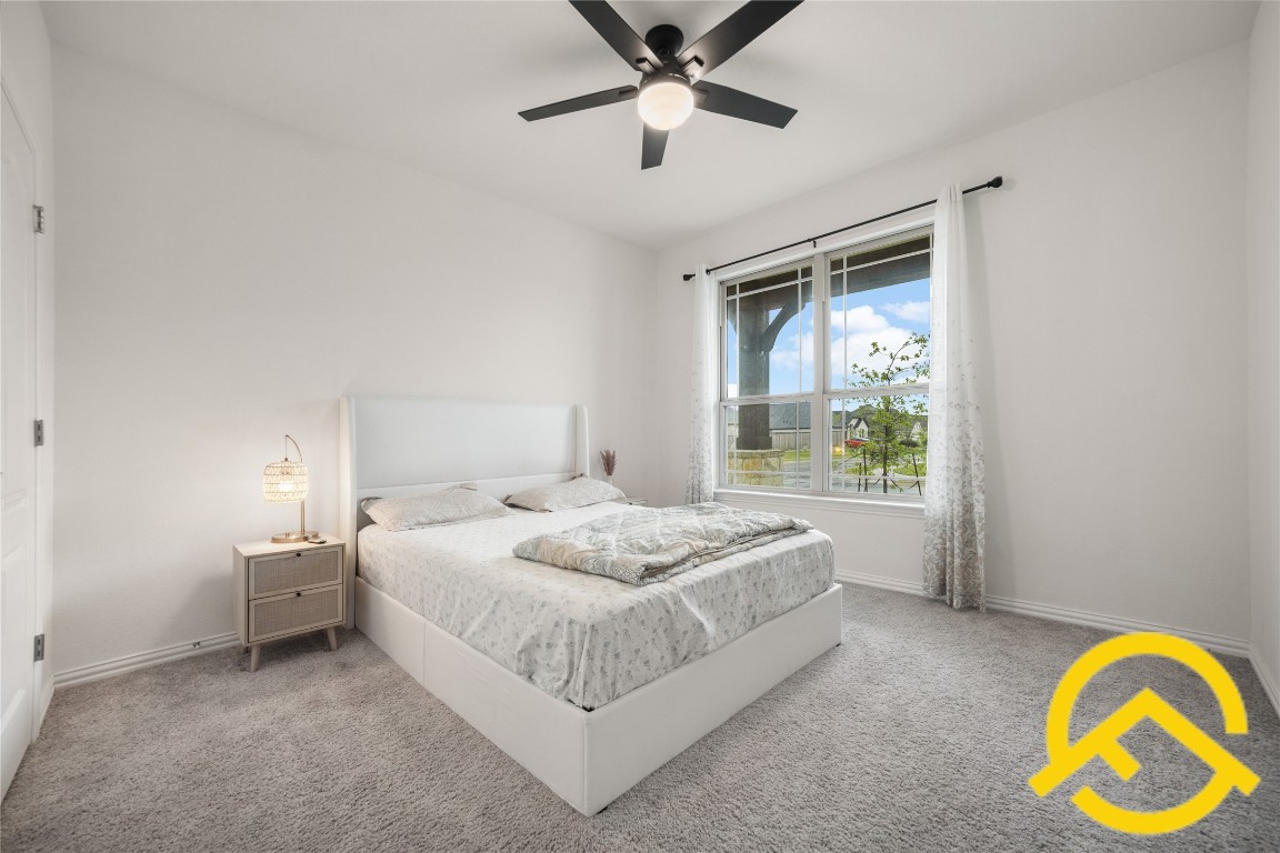 671 Durian Loop Buda, TX 78610 - Photo 17 of 29 a bedroom with a bed and a window