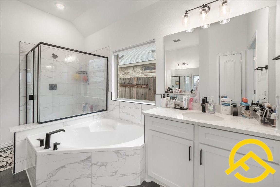 671 Durian Loop Buda, TX 78610 - Photo 19 of 29 a bathroom with a tub sink and mirror