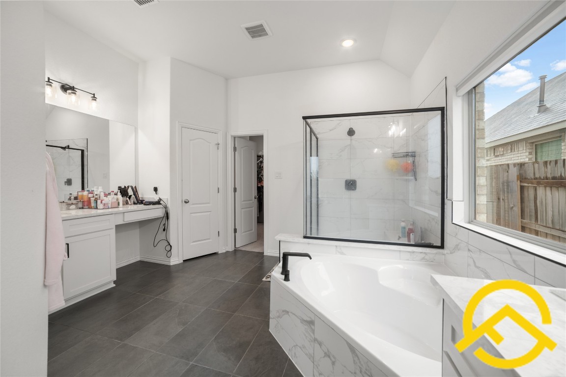 671 Durian Loop Buda, TX 78610 - Photo 20 of 29 a bathroom with a tub sink and mirror