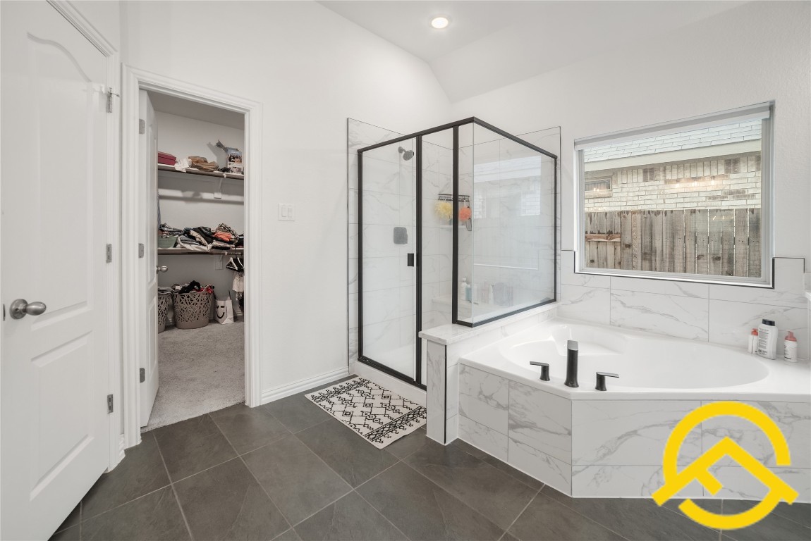671 Durian Loop Buda, TX 78610 - Photo 22 of 29 a bathroom with a tub and a shower