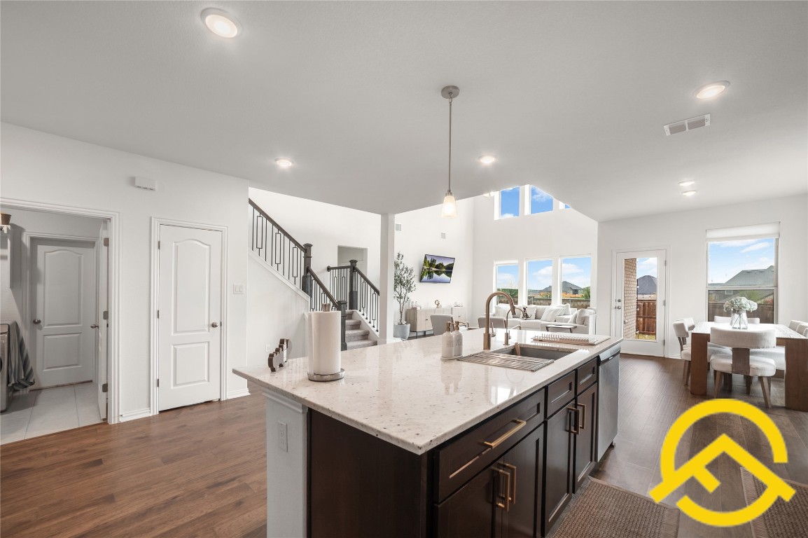 671 Durian Loop Buda, TX 78610 - Photo 28 of 29 a kitchen with stainless steel appliances granite countertop a sink and living room view