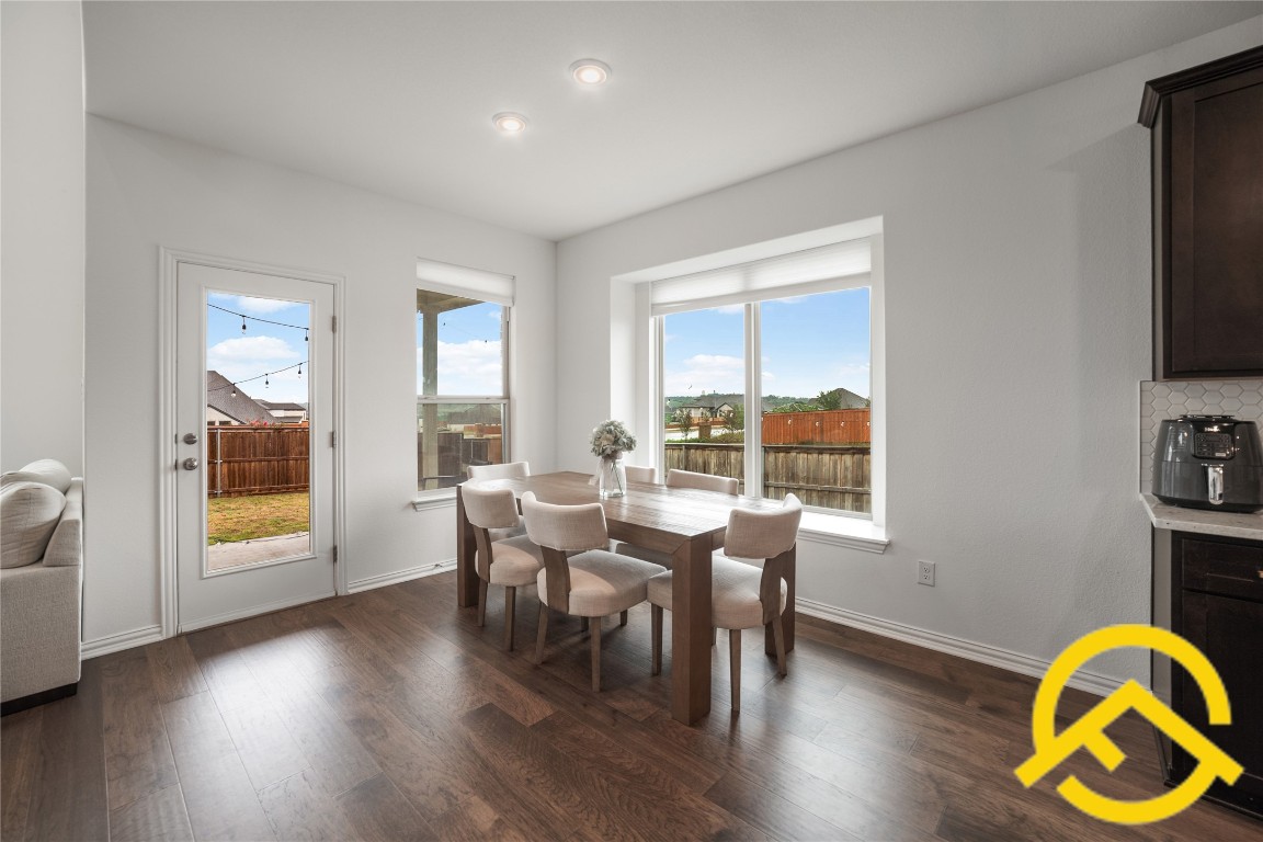 671 Durian Loop Buda, TX 78610 - Photo 6 of 29 a view of a dining room with furniture window and wooden floor