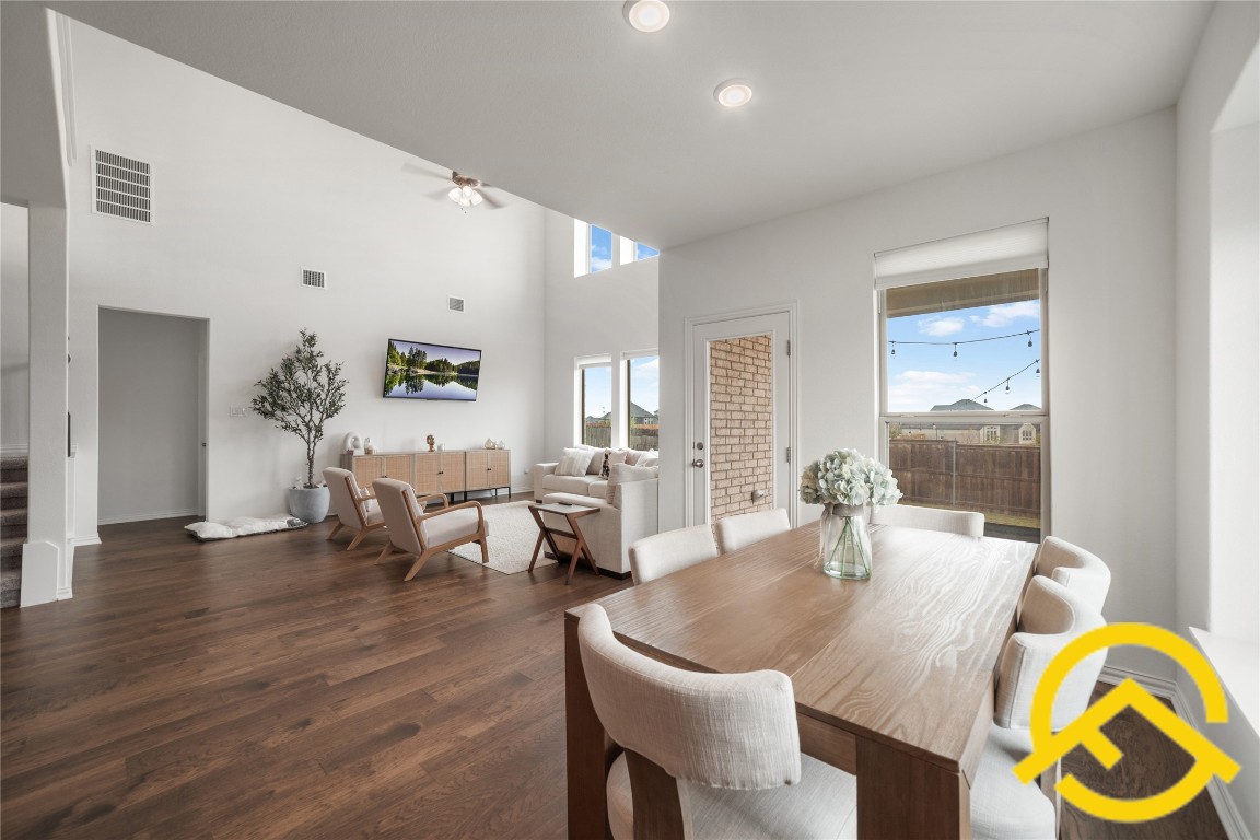 671 Durian Loop Buda, TX 78610 - Photo 7 of 29 a living room with dining table and wooden floor
