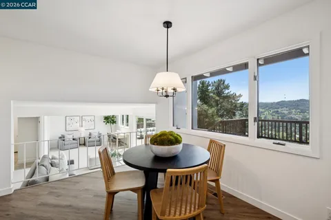 a view of a dining room with furniture window and outside view