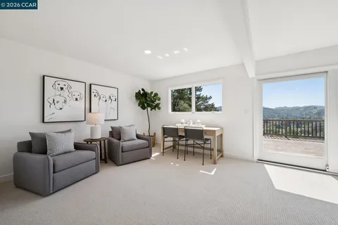 a living room with furniture a large window and a flat screen tv