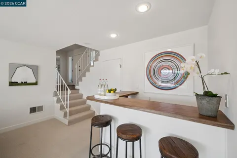 a dining room with furniture and a wooden floor