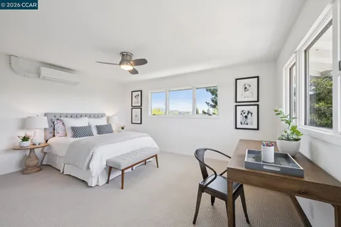 a bedroom with a bed and a desk