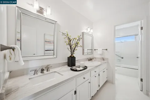 a bathroom with double vanity sink a mirror and vanity