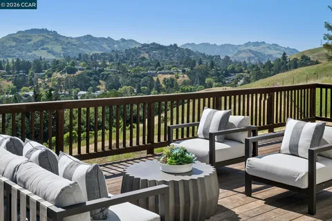 a view of a chairs and table on the deck