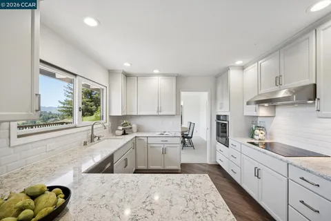 a kitchen with a sink a window and stainless steel appliances