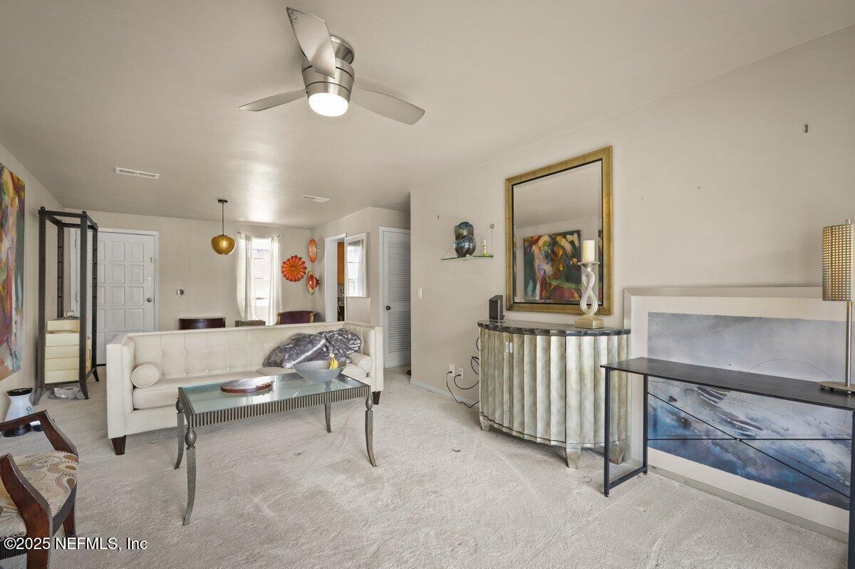 7346 El Barco Road, Unit 7 Jacksonville, FL 32216 - Photo 3 of 6 a living room with furniture and a chandelier