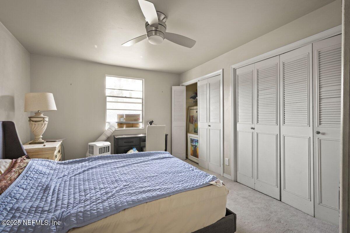 7346 El Barco Road, Unit 7 Jacksonville, FL 32216 - Photo 6 of 6 a bedroom with a large bed and a chandelier