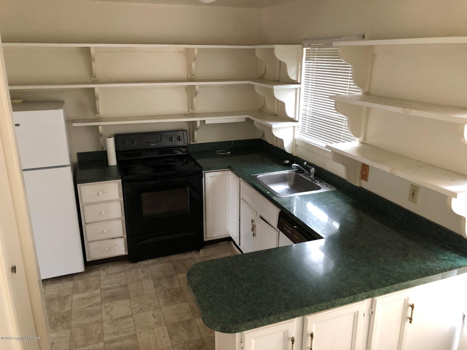 327 Crewe Court Bushkill, PA 18324 - Photo 5 of 10 a kitchen with a stove and a refrigerator