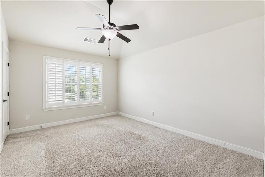 947 Hunter Way Milton, GA 30004 - Photo 66 of 78 an empty room with a window and a fan