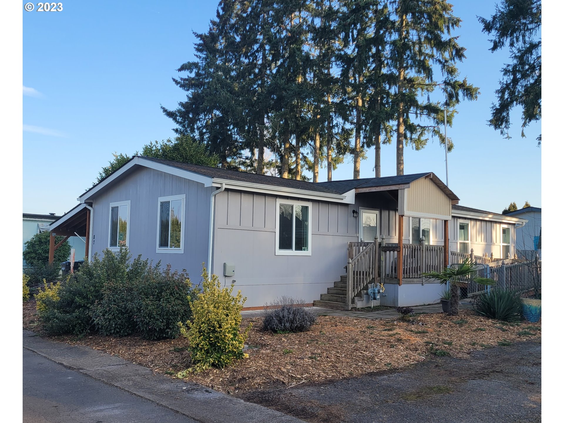 151 Edwards Road South, Unit 87 Monmouth, OR 97361 - Photo 1 of 18 a house with trees in the background