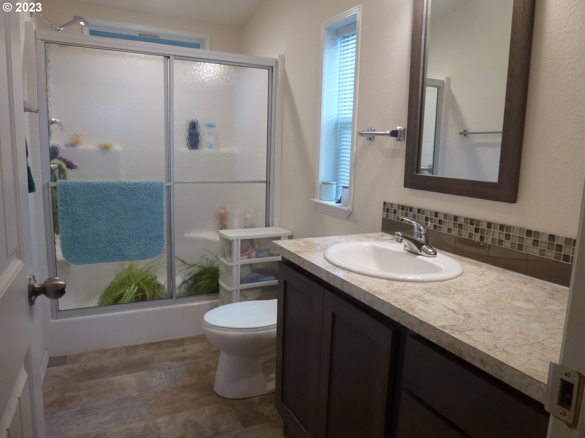 151 Edwards Road South, Unit 87 Monmouth, OR 97361 - Photo 12 of 18 a bathroom with a granite countertop sink and a mirror