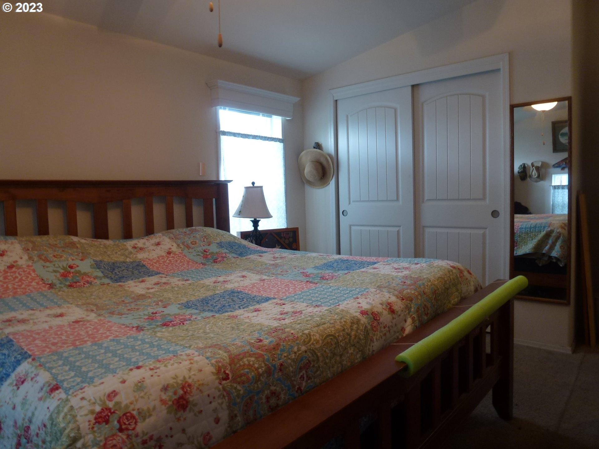 151 Edwards Road South, Unit 87 Monmouth, OR 97361 - Photo 14 of 18 a bedroom with a bed and a mirror