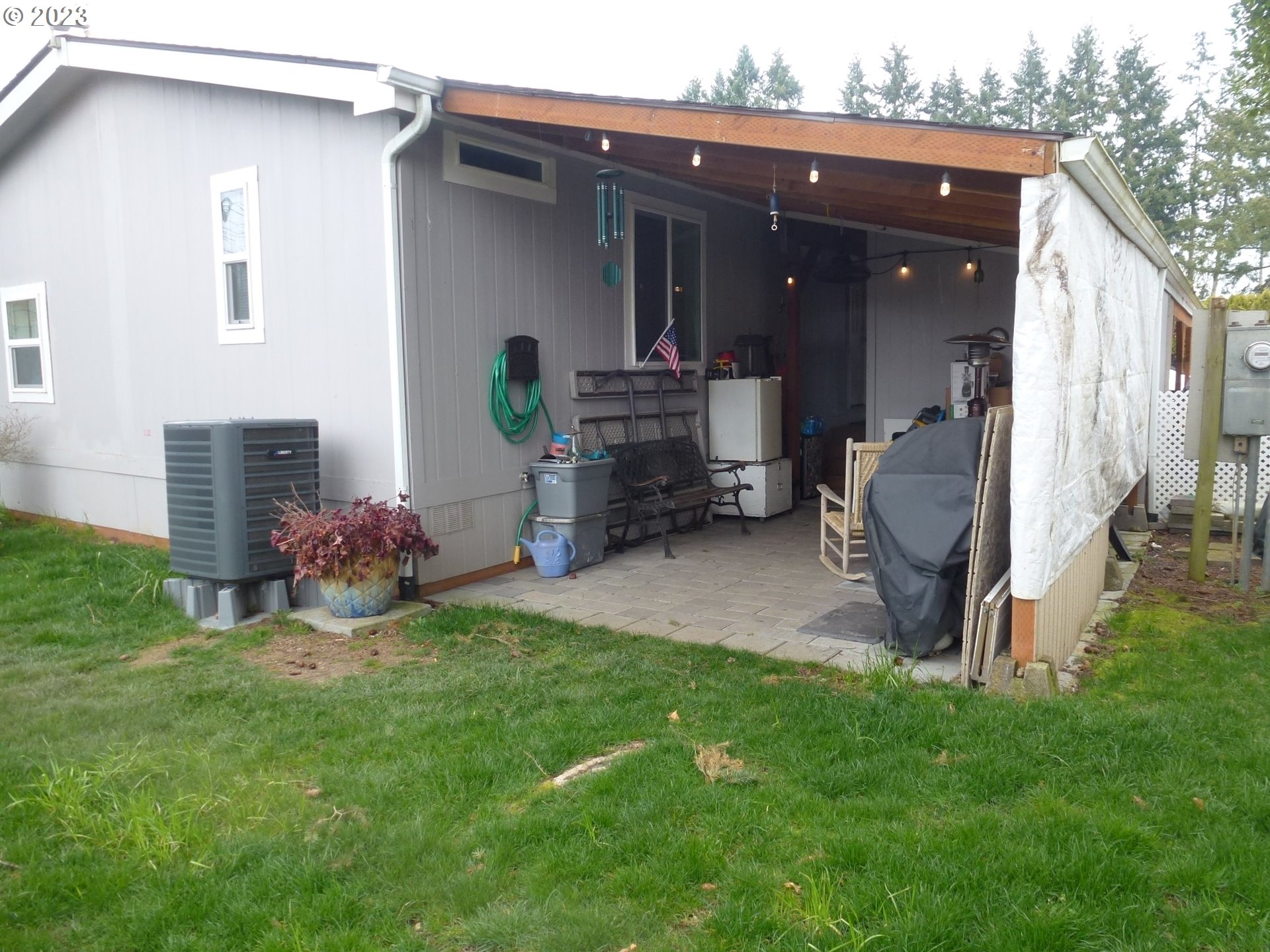 151 Edwards Road South, Unit 87 Monmouth, OR 97361 - Photo 16 of 18 a view of a porch with furniture and a yard