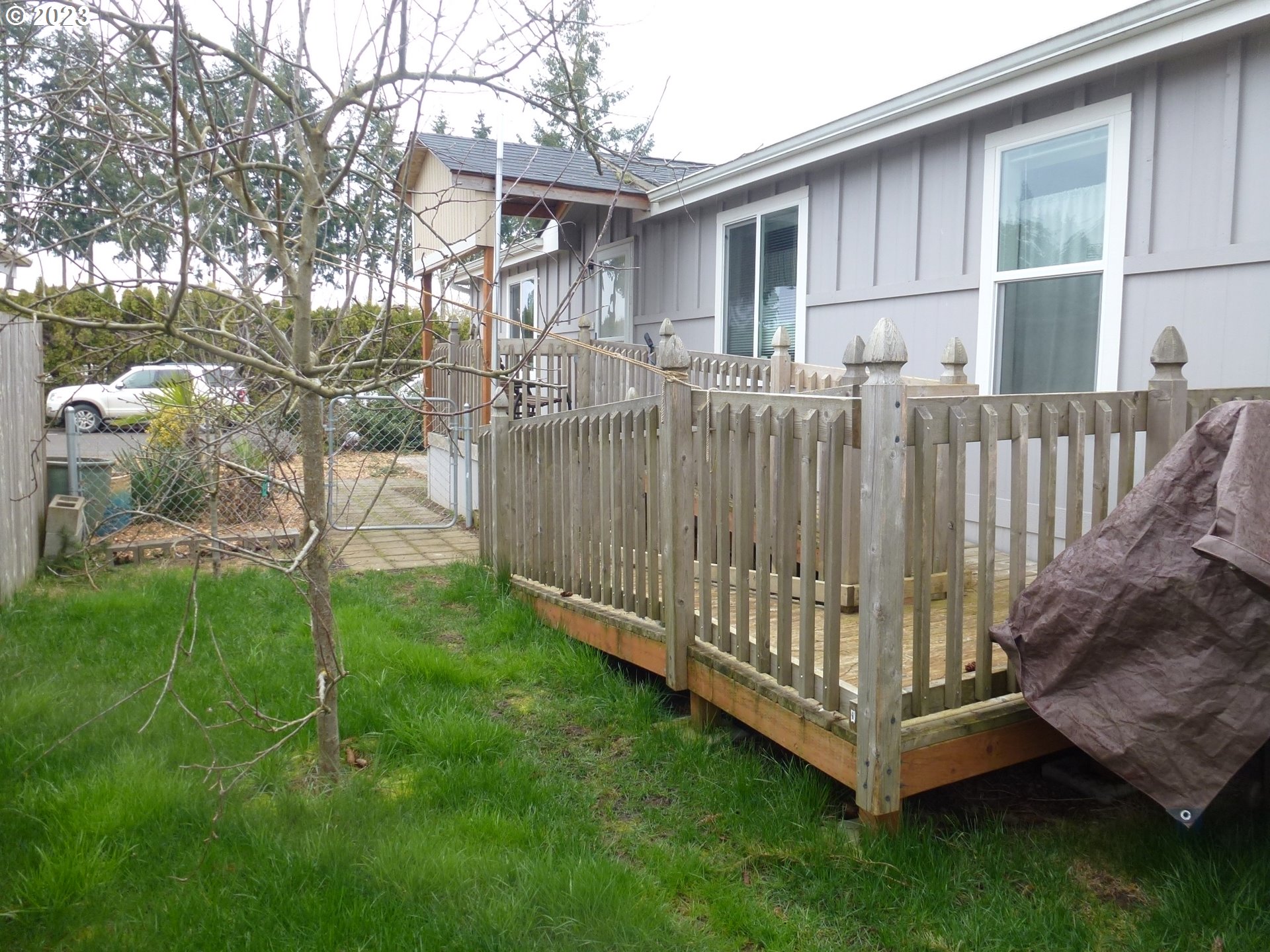 151 Edwards Road South, Unit 87 Monmouth, OR 97361 - Photo 18 of 18 a view of a house with backyard and wooden fence