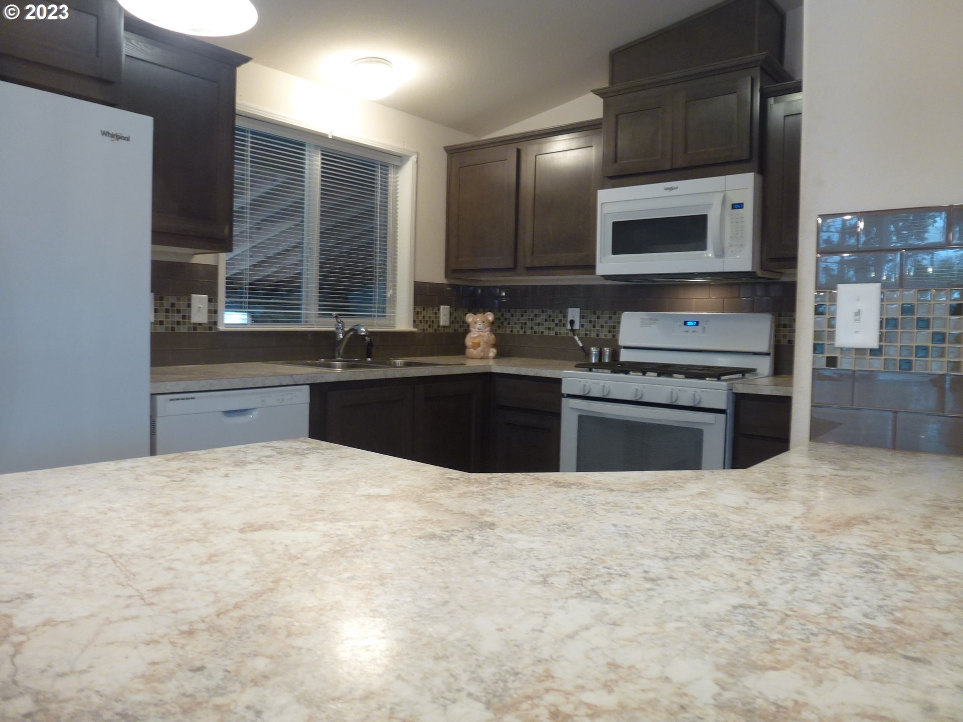 151 Edwards Road South, Unit 87 Monmouth, OR 97361 - Photo 7 of 18 a kitchen with stainless steel appliances a sink and a stove top oven