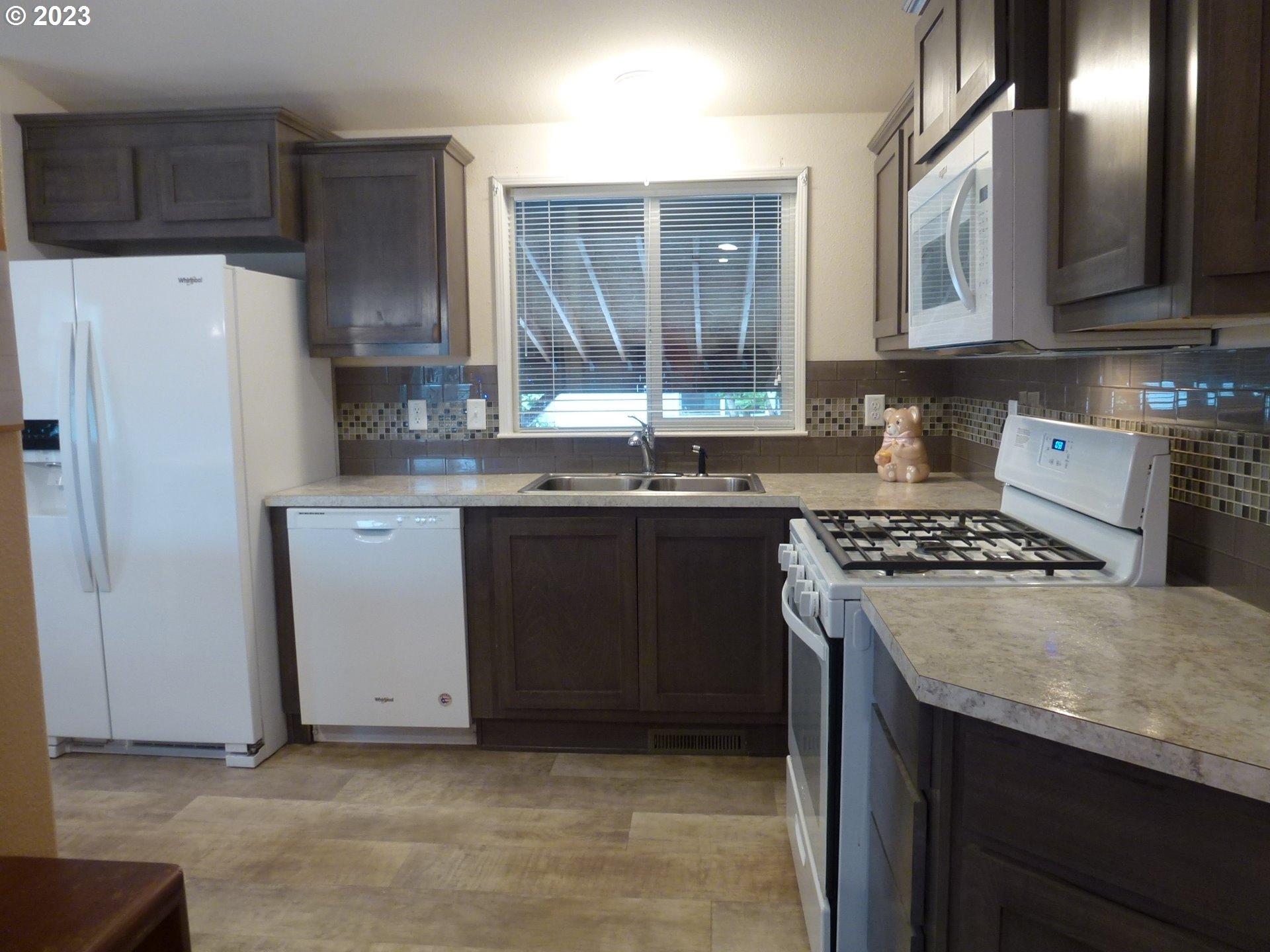 151 Edwards Road South, Unit 87 Monmouth, OR 97361 - Photo 9 of 18 a kitchen with stainless steel appliances a sink stove and refrigerator